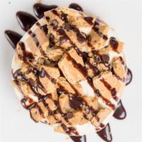Cookie Dough Cheesecake · Cream cheese frosting: topped with cookie dough, graham crackers and chocolate sauce.