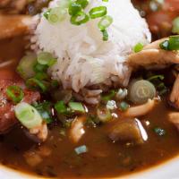 Gumbo · A hearty Cajun stew served over white rice. Served with chicken and sausage.