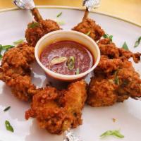 Chicken Lollipop · Chicken wings shaped like lollipops, seasoned in a mild red batter, and crispy fried.