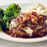 Fontina Pork Chop · Bone-in pork chop, Fontina cheese, garlic, prosciutto and mushroom marsala wine sauce