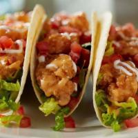 Bang Bang Shrimp® Tacos · our signature Bang Bang Shrimp®, greens, tomatoes and sour cream