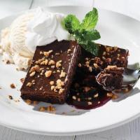 Macadamia Nut Brownie · flourless brownie, raspberry sauce, vanilla ice cream, sprinkled with macadamia nuts