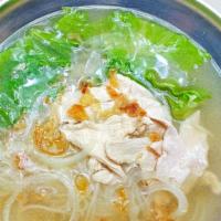 Chicken Pho Noodle Soup · rice noodles, sliced chickens, green leaves and bean sprout in a clear broth top sliced onio...