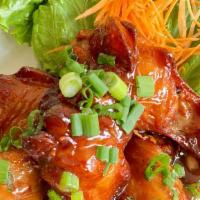 Chicken Wings Tamarind · Deep-fried chicken wings mixed tamarind sauce top sliced green onions.