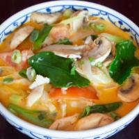 Tom Kha · Coconut milk soup with tomato, mushroom, yellow onion, and green onion.
