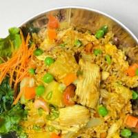 Pineapple Fried Rice · Stir-fried with rice, egg, pineapple,  onion, raisin, cashew nut, pea, carrot, and curry pow...