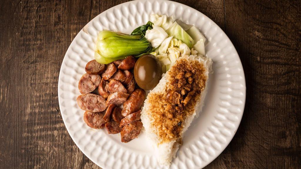 Taiwan Sausage Over Rice · All rice dishes include an egg, Taiwanese style kimchi, and vegetables.