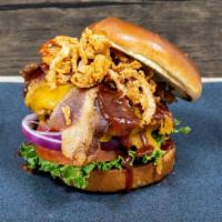 Backyard Burger · 1/2 lb. beef patty, Cheddar cheese, bacon, fried onions strings, smoked BBQ sauce, lettuce, ...