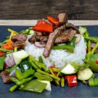 Pepper Steak · Marinated flank steak, bell peppers, onions, carrots, white rice and seasoned vegetables.