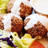 Falafel Plate · 3 Falafels on rice with a side of hummus and salad.