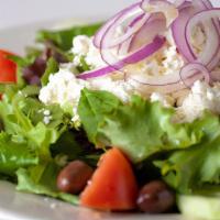 Greek Salad · Seasonal mixed greens, tomatoes, cucumbers, red onions, feta, kalamata olives, and lemon vin...