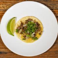 Carne Asada Street Tacos · Grilled ribeye steak. Street tacos are served with sautéed onions, cilantro and limon on two...