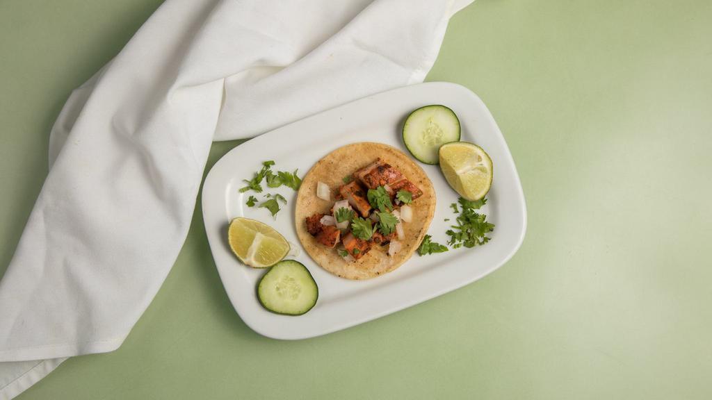 Pollo Taco · Popular. Grilled marinated chicken street taco includes onions and cilantro on top. Green sauce and red sauce on the side as well as cucumbers and lime on the side.