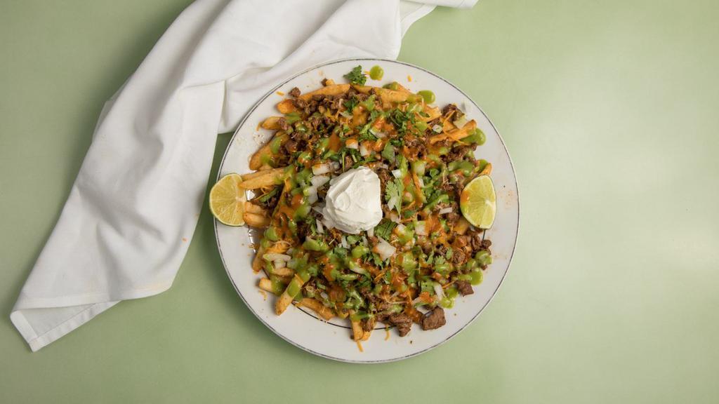 Carne Asada Fries · Popular. Carne asada, shredded cheese, onions, cilantro, sour cream, green sauce, red sauce, and topped with lime juice.