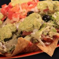 Nachos · Crispy tortilla chips topped with beans, nacho cheese, choice of meat, lettuce, sour cream, ...