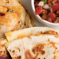 Quesadilla · Large flour tortilla filled with melted cheese and choice of meat with a side of salad and  ...