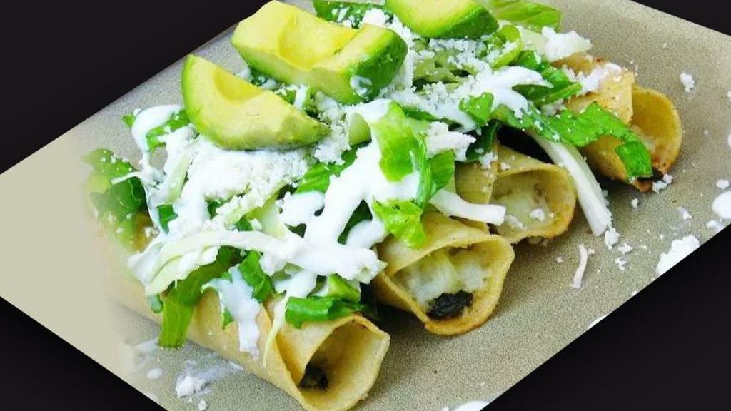 Tacos Dorados · Four rolled deep fried tacos, with chicken and cheese inside. Topped with lettuce, sour cream, salsa, cheese, and avocado.
