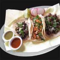 Tacos · Corn tortilla with your choice of meat, onions, and cilantro. Radishes, lime, sauteed onions...