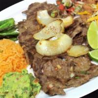 Carne Asada · Grilled beef with cooked onions and served with rice, beans, and small salad with your choic...