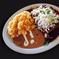 Enmolada · Three soft rolled tacos with chicken bathed in mole sauce with lettuce, sour cream, green sa...