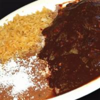 Mole De Pollo · Whole pieces of chicken bathed in mole sauce served with rice and beans along with your choi...