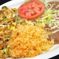 Huevos A La Mexicana · Four scrambled eggs with onions, tomatoes and jalapenos. Served with rice and beans, along w...