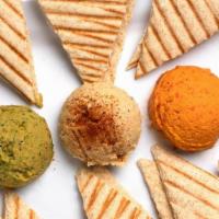 Hummus Trio · Our housemade Roasted Garlic, Spicy Avocado Hummus, and Roasted Red Pepper Hummus. Served wi...