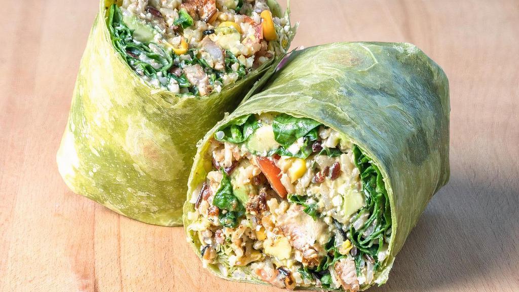 Southwest Wrap · Wild Rice Blend, Southwestern Chicken, Spinach, Roasted Corn, Avocado, Tomatoes, Cotija Cheese with Cilantro Chili Lime Dressing in a Spinach Tortilla