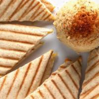 Roasted Garlic Hummus · Roasted garlic blended with chickpeas, herbs and spices. Served with wedges of warm pita bre...