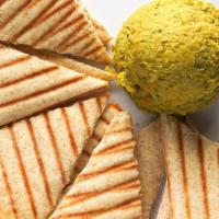 Spicy Avocado Hummus · A flavorful blend of avocado, jalapenos, chickpeas, herbs and spices. Served with wedges of ...