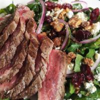 Flank Steak Salad · This salad has candied walnuts, dried cranberries, and gorgonzola on arugula, topped with gr...