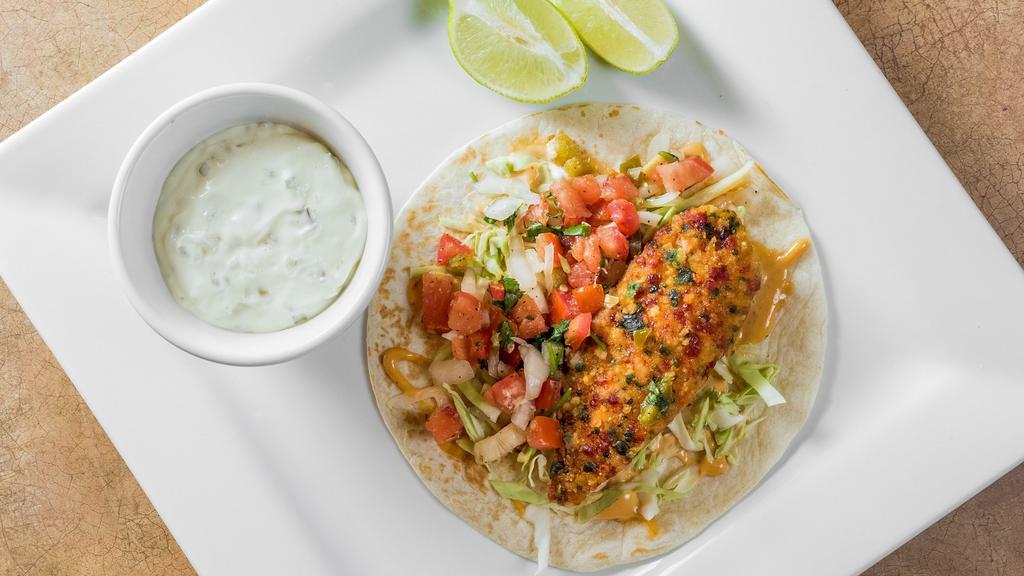 The Flying Pescado · Breaded tilapia with tartar sauce, pico de gallo & cabbage in a soft shell tortilla. Add Extra Toppings for an additional charge.