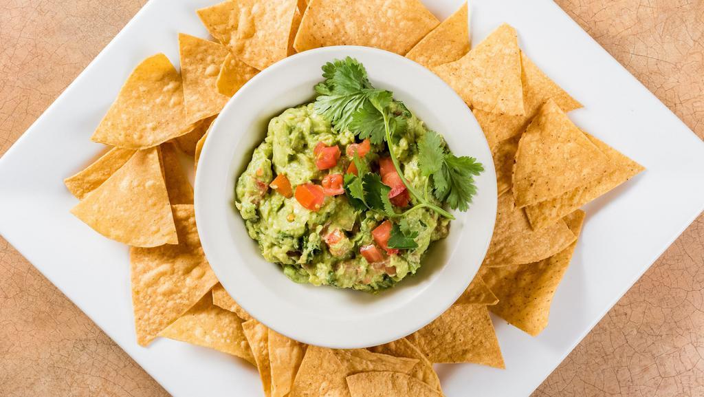 Holy Guac · A heaping scoop of fresh guacamole and warm tortilla chips.