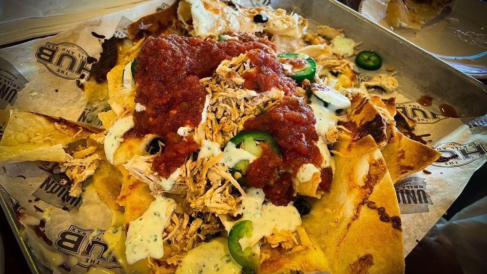 Nachos · UNION queso, jack cheese, tortilla chips, cowboy caviar, jalapeño cilantro crema, sliced fresh jalapeño, side of house salsa