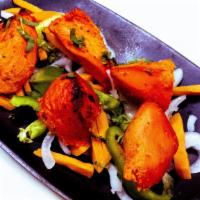 Chicken Tikka · Boneless chicken breast meat marinated in spices and cooked in tandoor oven.