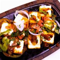 Royal Paneer · Home made cheese sauteed with onions carrots bell peppers and spices served on a sizzling pl...
