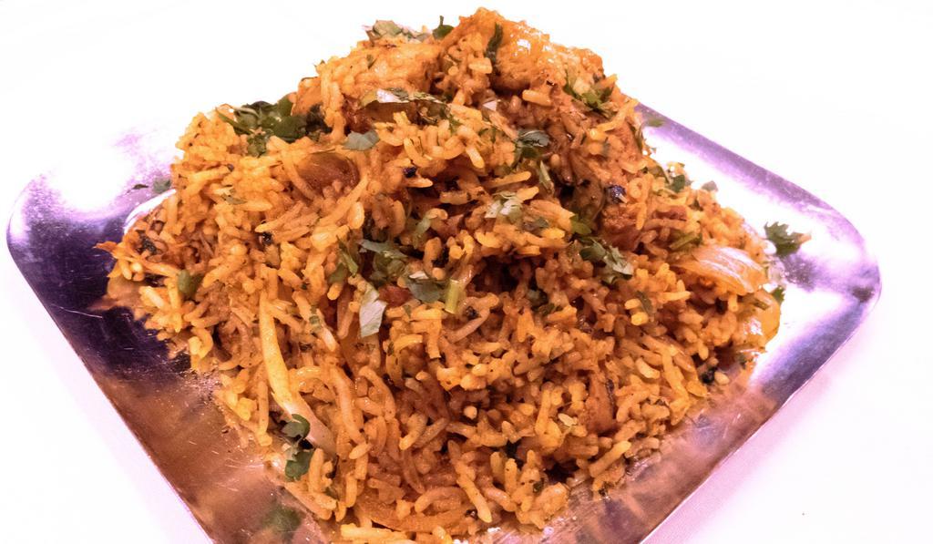 Chicken Biryani · Aromatic basmati rice and chicken pieces cooked with herbs butter and spices.