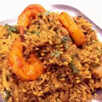 Shrimp Biryani · Aromatic basmati rice with shrimp cooked with herbs butter and spices.