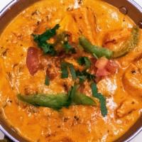 Chicken Tikka Masala · Boneless chicken breast pieces cooked with bell peppers cream tomatoes and spices.