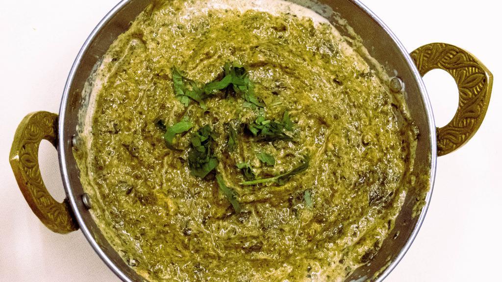 Shrimp Saag · Shrimp cooked with spinach onions spices and cream.