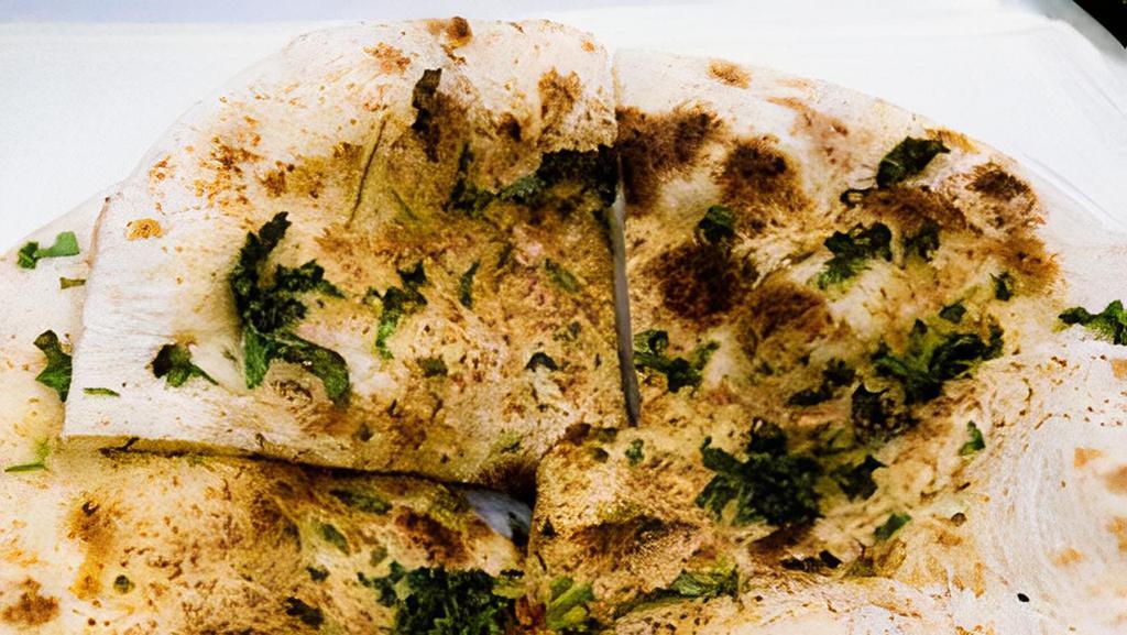 Garlic Naan · Traditional indian bread baked in tandoor oven with garlic.