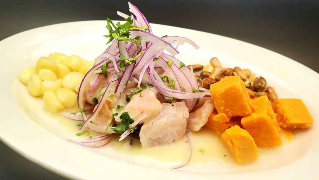 Ceviche Clásico · Gluten free. Fresh rockfish marinated in a delicious tiger milk, accompanied with sweet potato, white corn, Andean corn, and finely sliced onion.