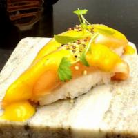 Nigiri Chalaco · Gluten free. Fresh salmon covered in ají amarillo sauce, crispy quinoa, cilantro and rocoto ...