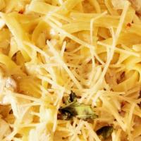 Fettuccine Carbonara · Fettuccine pasta tossed with bacon, scallions, mushrooms, and diced tomatoes in a Parmesan c...