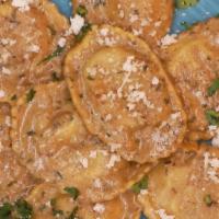 Wild Mushroom Ravioli · Local wild mushroom ravioli with a porcini cream sauce with light chili flakes, served with ...