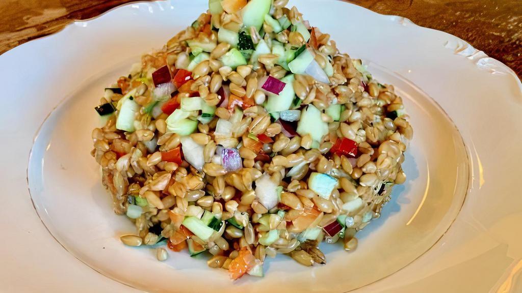 Farro Salad · A classic Tuscan salad made with organic ancient grain farro tossed with cucumbers, peppers, red onions, arbequina olive oil, and assorted herbs and spices. Vegan.