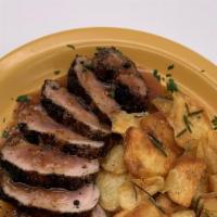 Grilled Pork Tenderloin · Pork tenderloin encrusted with black pepper, served with a veal reduction and Tuscan fries.