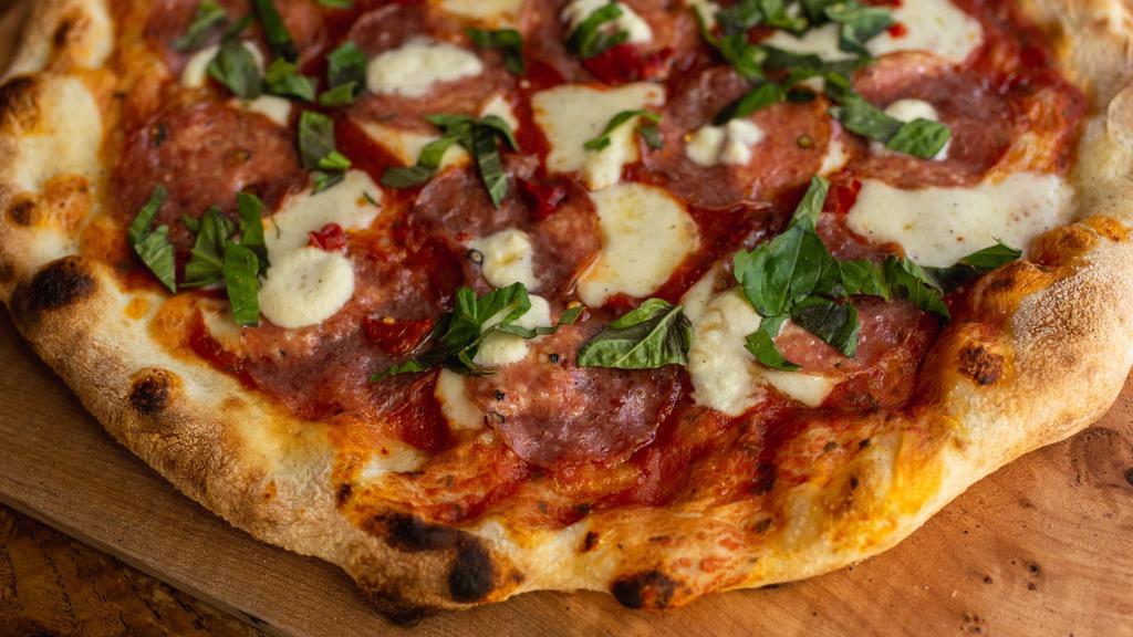 Soppressata Pizza · Northern Italian salami, locally made ricotta, mozzarella, tomato sauce, basil, Calabrian chili, honey.