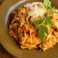 Pappardelle Alla Bolognese · Beef, pork, chicken liver and tomato braised in a medley of garden vegetables, with fresh he...