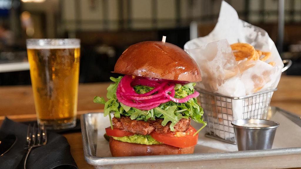 Veggie Burger · beyond burger, smashed avocado, arugula, pickled onions, heirloom tomatoes, brioche bun served with fries, chips, side salad or soup